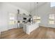 Bright kitchen features white counters, stainless steel appliances, tile backsplash and modern pendant lighting at 22212 Sw 210Th Ave, Dunnellon, FL 34431
