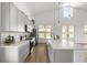 Bright kitchen features white counters, stainless steel appliances, tile backsplash, and a farm sink at 22212 Sw 210Th Ave, Dunnellon, FL 34431