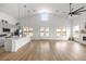 Open-concept living area with vaulted ceilings, modern kitchen, and beautiful wood flooring at 22212 Sw 210Th Ave, Dunnellon, FL 34431