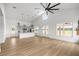 Spacious open-concept living area with a modern kitchen, vaulted ceilings, and hardwood floors at 22212 Sw 210Th Ave, Dunnellon, FL 34431