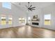Bright living room featuring vaulted ceilings, fireplace, and large windows with scenic views at 22212 Sw 210Th Ave, Dunnellon, FL 34431