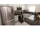 Modern kitchen featuring stainless steel appliances and dark countertops, providing a sleek and functional space at 2241 Retreat View Cir, Sanford, FL 32771