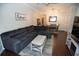 Comfortable living room with wood floors, a large couch, and a decorative 'Home' wall hanging at 2241 Retreat View Cir, Sanford, FL 32771
