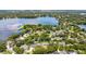 An aerial view showcases a neighborhood with many homes nestled among the trees near a picturesque lake at 2527 Shrewsbury Rd, Orlando, FL 32803