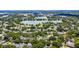 An aerial view shows a home nestled among trees, with a lake and buildings in the distance at 2527 Shrewsbury Rd, Orlando, FL 32803