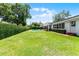 Expansive backyard with a pool, patio, manicured lawn, and privacy hedges at 2527 Shrewsbury Rd, Orlando, FL 32803