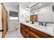 Well-lit bathroom showcases double vanity with a dark wood finish, white counter, and a tiled floor at 2527 Shrewsbury Rd, Orlando, FL 32803