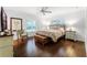 Serene bedroom with hardwood floors, plantation shutters, ceiling fan, and neutral decor at 2527 Shrewsbury Rd, Orlando, FL 32803