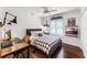 Cozy bedroom with wood floors, a ceiling fan, and a charming desk area with custom lighting at 2527 Shrewsbury Rd, Orlando, FL 32803