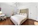 Bright bedroom features a plush bed, hardwood floors, and a surfboard accent for a coastal vibe at 2527 Shrewsbury Rd, Orlando, FL 32803