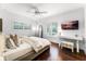 Stylish bedroom featuring a window, desk, plush bed, and hardwood floors at 2527 Shrewsbury Rd, Orlando, FL 32803