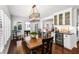 Inviting dining area with wood table, chairs, a wine refrigerator, and lots of natural light at 2527 Shrewsbury Rd, Orlando, FL 32803
