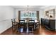 Elegant dining room featuring a wood table with seating for six, hardwood floors, and wainscoting at 2527 Shrewsbury Rd, Orlando, FL 32803