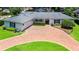 Aerial view of home, showing a well-manicured lawn, brick driveway, and white exterior paint at 2527 Shrewsbury Rd, Orlando, FL 32803