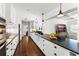 Modern kitchen with white cabinets, dark countertops, stainless steel appliances, and hardwood floors at 2527 Shrewsbury Rd, Orlando, FL 32803