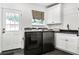 Laundry area equipped with modern washer and dryer units, a sink, and practical storage solutions at 2527 Shrewsbury Rd, Orlando, FL 32803