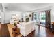 Spacious living room with hardwood floors, white sofas, French doors, and ample natural light at 2527 Shrewsbury Rd, Orlando, FL 32803