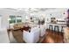 Open-concept living space with hardwood floors, white sofas, barstool seating, and lots of light at 2527 Shrewsbury Rd, Orlando, FL 32803