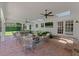 Covered patio features brick flooring, an outdoor living space, and serene views of the landscaped backyard at 2527 Shrewsbury Rd, Orlando, FL 32803