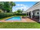 Inviting backyard swimming pool area with brick patio, lounge chairs, and covered outdoor seating at 2527 Shrewsbury Rd, Orlando, FL 32803