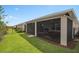 The backyard features a manicured lawn, landscaped borders, and a view of the neighborhood at 2759 Purple Meadow Ct, Minneola, FL 34715