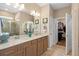 Spacious bathroom featuring dual sinks, tile flooring, walk-in shower, and walk-in closet at 2759 Purple Meadow Ct, Minneola, FL 34715