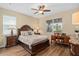 This bedroom boasts wood floors, neutral walls, ceiling fan and elegant furniture, creating a cozy retreat at 2759 Purple Meadow Ct, Minneola, FL 34715
