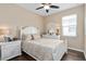 Cozy bedroom featuring a white bed frame, matching nightstands, and warm neutral color tones at 2759 Purple Meadow Ct, Minneola, FL 34715