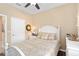 Charming bedroom features a white wooden bed frame, matching nightstands, and hardwood flooring at 2759 Purple Meadow Ct, Minneola, FL 34715