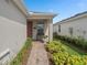 Inviting front porch with brick walkway, decorative bench, and lush landscaping, enhancing curb appeal at 2759 Purple Meadow Ct, Minneola, FL 34715