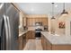 Bright kitchen features stainless steel appliances, granite countertops, and modern pendant lighting at 2759 Purple Meadow Ct, Minneola, FL 34715