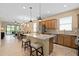 Modern kitchen with a granite island, stainless steel appliances, and a seamless transition to dining area at 2759 Purple Meadow Ct, Minneola, FL 34715