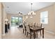 Bright living room with tile flooring, a ceiling fan, and sliding glass doors to the patio at 2759 Purple Meadow Ct, Minneola, FL 34715