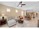 Open living space connects to the dining room and kitchen, with tile flooring and natural light at 2759 Purple Meadow Ct, Minneola, FL 34715