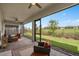 Comfortable covered patio offering a view of the well-manicured lawn and neighborhood at 2759 Purple Meadow Ct, Minneola, FL 34715