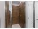 A bathroom shower featuring wood look tile and a glass enclosure at 308 Clearwater Ln, Poinciana, FL 34759