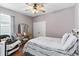Bedroom features a ceiling fan, double closet, and large window at 308 Clearwater Ln, Poinciana, FL 34759
