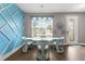 Elegant dining area features a glass table, contemporary chairs, and unique wall accents at 308 Clearwater Ln, Poinciana, FL 34759