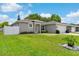 Beautifully landscaped front yard with a well-kept lawn and matching neighboring homes at 308 Clearwater Ln, Poinciana, FL 34759
