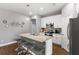 Modern kitchen with a granite countertop island, stainless steel appliances, and ample cabinet space at 308 Clearwater Ln, Poinciana, FL 34759