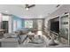 Open-concept living area showcasing stylish furniture, a dining area, and kitchen in the background at 308 Clearwater Ln, Poinciana, FL 34759
