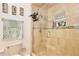 Modern bathroom featuring a glass-enclosed shower, tiled walls, and decorative fixtures at 3415 Celena Cir, St Cloud, FL 34769