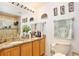 Spacious bathroom with double sinks, granite countertops, decorative accessories, and tiled shower at 3415 Celena Cir, St Cloud, FL 34769