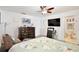 Bright bedroom featuring a ceiling fan, dresser, and a view into an ensuite bathroom at 3415 Celena Cir, St Cloud, FL 34769