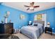 Stylish bedroom with a comfortable queen-size bed, ceiling fan, and decorative accents at 3415 Celena Cir, St Cloud, FL 34769