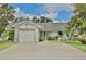 Charming single-story home with an attached garage and well-maintained landscaping at 3415 Celena Cir, St Cloud, FL 34769