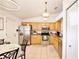 Well-equipped kitchen with stainless steel appliances, light wood cabinets and adjacent dining area at 3415 Celena Cir, St Cloud, FL 34769