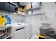 Organized laundry room with modern washer and dryer, shelving, and ample storage space at 3415 Celena Cir, St Cloud, FL 34769
