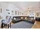 Bright living room featuring a large leather sectional, vaulted ceilings, and modern decor at 3415 Celena Cir, St Cloud, FL 34769