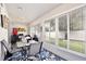 Bright sunroom with tile floor, large windows with white blinds, and stylish decor at 3415 Celena Cir, St Cloud, FL 34769